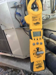 Eugene AC repair technician diagnosing a cooling system that was blowing warm air during a hot afternoon
