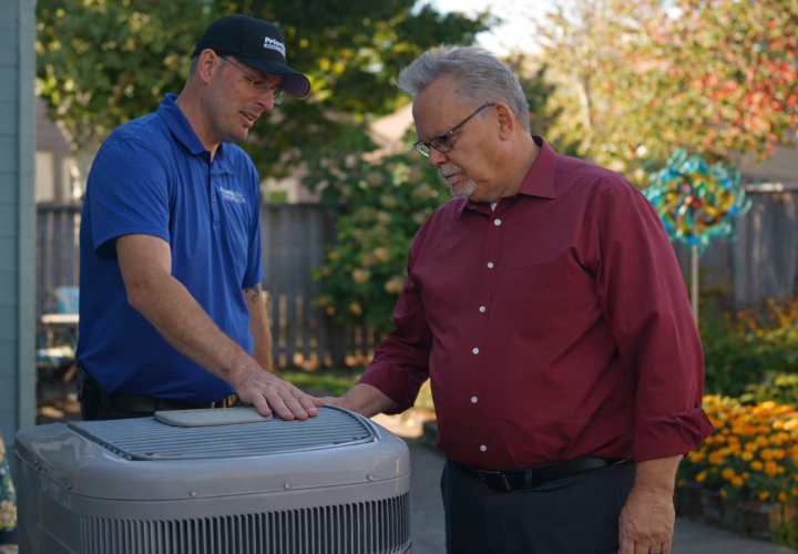 HVAC technician discussing maintenance with a homeowner